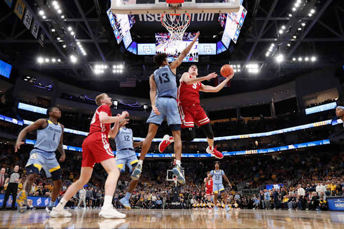 Dec 3, 2022; Milwaukee, Wisconsin, USA; Wisconsin Badgers forward Tyler Wahl (5) shoots around Marquette Golden Eagles forward Oso Ighodaro (13) during the second half at Fiserv Forum. Mandatory Credit: Jeff Hanisch-USA TODAY Sports